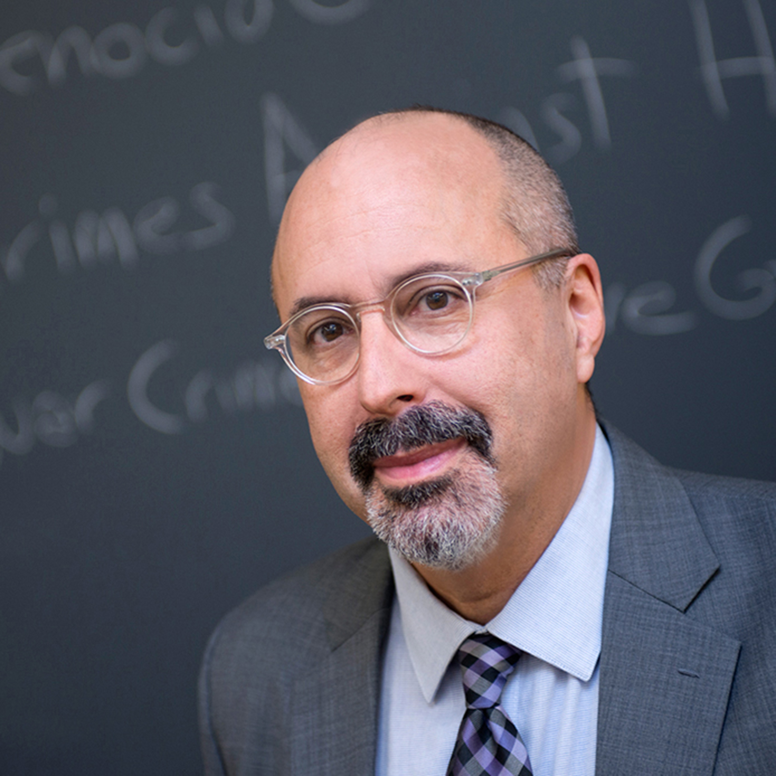 Photo of Professor Mark Osiel in front of a chalk board