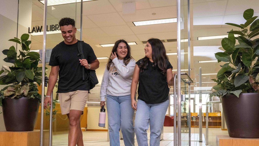 Three students exiting the Law Library